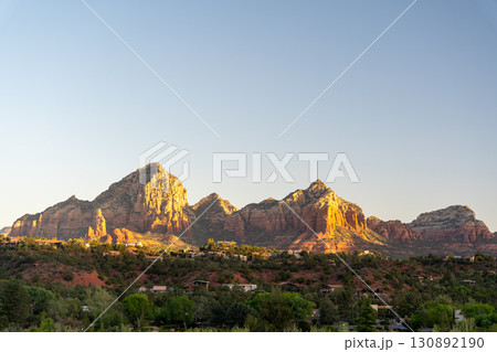 Golden sunset illuminates Sedona red rock formations and scenic desert landscape 130892190