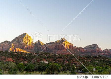 Golden sunset illuminates Sedona red rock formations and scenic desert landscape Golden sunset illuminates Sedona red rock formations and scenic desert landscape 130892192