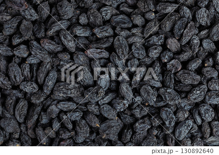 black raisins as a background. Top view. Flat lay black raisins as a background. Top view. Flat lay 130892640