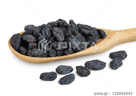 black raisins in wooden spoon isolated on white background 130892643