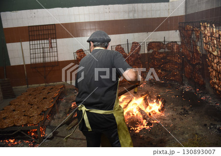 Gaucho roast barbecue, sausage and cow ribs, traditional argentine cuisine, Patagonia, Argentina. 130893007