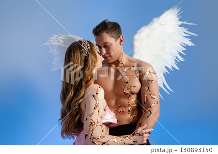 Romantic moment between angel couple with wings and nature details 130893150