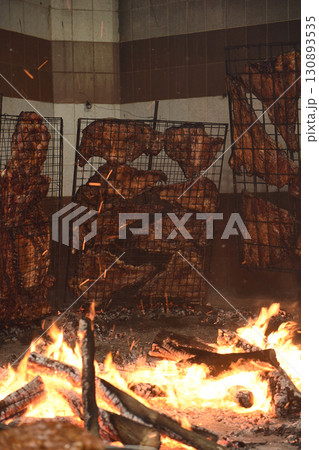 Barbecue, sausage and cow ribs, traditional argentine cuisine, Patagonia, Argentina. Barbecue, sausage and cow ribs, traditional argentine cuisine, Patagonia, Argentina. 130893535
