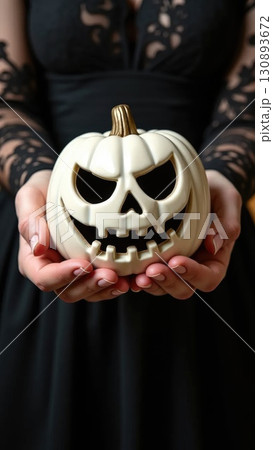 Elegant Hands in Black Lace Holding White Victorian Jack-o-Lantern Elegant Hands in Black Lace Holding White Victorian Jack-o-Lantern 130893672