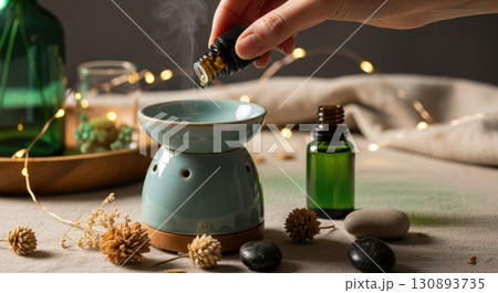 Hand Adding Essential Oil to Boho Diffuser Hand Adding Essential Oil to Boho Diffuser 130893735