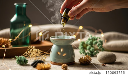 Hand Adding Essential Oil to Boho Diffuser Hand Adding Essential Oil to Boho Diffuser 130893736