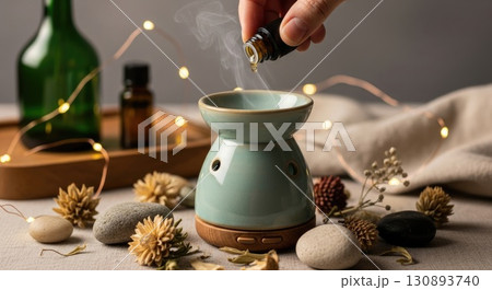 Hand Adding Essential Oil to Boho Diffuser Hand Adding Essential Oil to Boho Diffuser 130893740