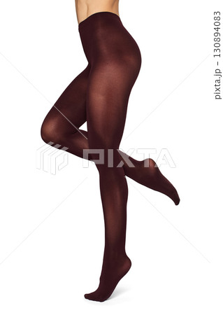 Beautiful long fit female legs in maroon tights on white background Beautiful long fit female legs in maroon tights on white background 130894083