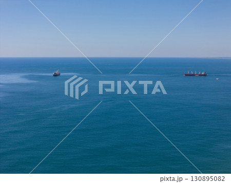 Cargo vessel ship at blue sea 130895082