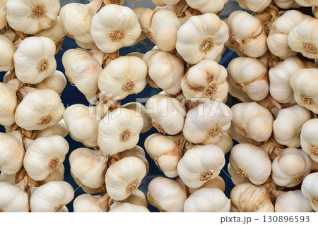Dry garlic is hanging on the market 130896593