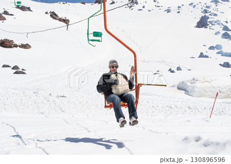 Male tourist on a old funicular. Russia's North Caucasus. Elbrus mountain Male tourist on a old funicular. Russia's North Caucasus. Elbrus mountain 130896596