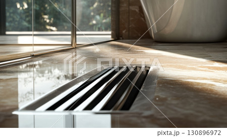 Stainless steel floor drain in contemporary bathroom interior 130896972