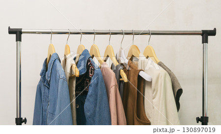 Collection of upcycled second-hand denim and fashion pieces displayed on a rack. Eco thrifting life. Collection of upcycled second-hand denim and fashion pieces displayed on a rack. Eco thrifting life. 130897019