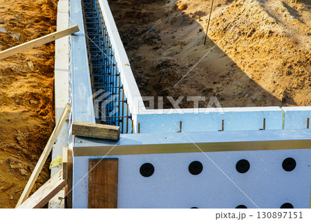 ICF foundation wall with visible rebar reinforcement during construction at modern building site 130897151