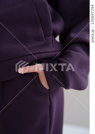 Purple hoodie with pocket and cuff. Close-up of sleeve of warm tracksuit. Purple hoodie with pocket and cuff. Close-up of sleeve of warm tracksuit. 130897294