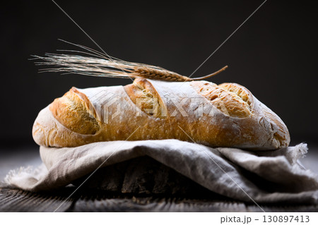 Homemade sourdough baguette bread with cracked crust Homemade sourdough baguette bread with cracked crust 130897413