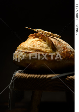 Homemade sourdough bread with cracked crust and rugged texture Homemade sourdough bread with cracked crust and rugged texture 130897414