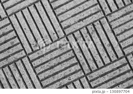 Textured concrete surface with diagonal grooves and patterns in a monochrome setting Textured concrete surface with diagonal grooves and patterns in a monochrome setting 130897704