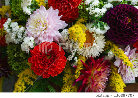 Colorful autumn flower arrangement featuring vibrant blossoms for a festive occasion Colorful autumn flower arrangement featuring vibrant blossoms for a festive occasion 130897707