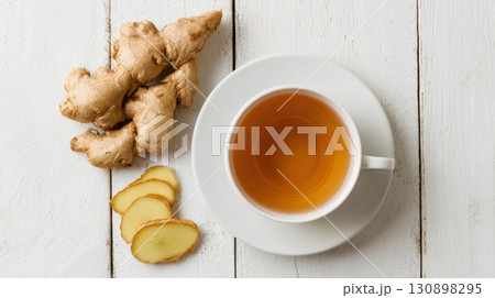 Fresh ginger root with sliced pieces on a rustic wooden background 130898295