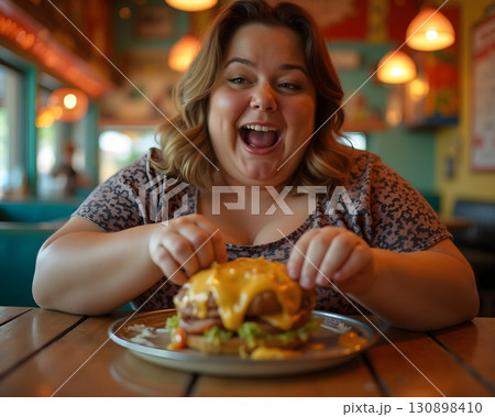 Joyful moment in a cozy diner while enjoying a delicious cheeseburger on a sunny afternoon 130898410