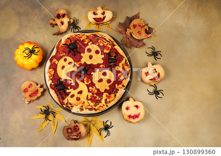 Halloween food concept, holiday meal idea for kids and adults. Scary pizzas and cookies in the form of monsters and ghosts on an old concrete background, cafe and menu advertising, Halloween food concept, holiday meal idea for kids and adults. Scary pizzas and cookies in the form of monsters and ghosts on an old concrete background, cafe and menu advertising, 130899360