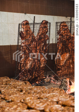 Barbecue, sausage and cow ribs, traditional argentine cuisine, Patagonia, Argentina. 130899383