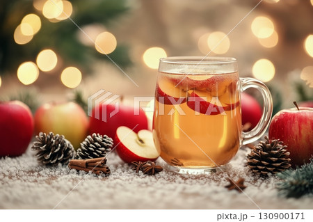 Warm Apple Drink Surrounded by Festive Decorations and Winter Elements 130900171