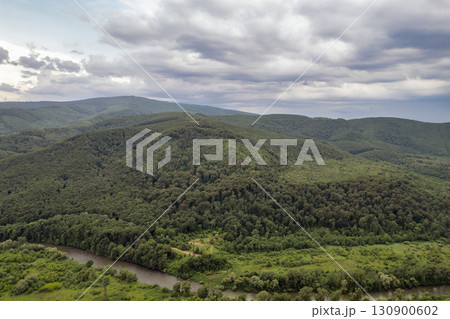Green hills and forest landscape in summer. Chynadiieve, Ukraine. 130900602