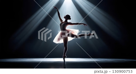 Silhouette of ballerina in graceful dance pose with glowing spotlight, cinematic elegant stage scene 130900753