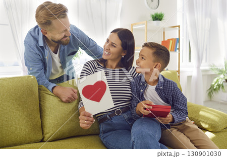 Happy beautiful woman receives present from loving husband and son on Mother's Day 130901030