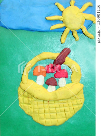 A basket of mushrooms made from plasticine. Childish art. Children's creativity 130901116