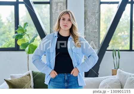Portrait of young beautiful smiling woman in home interior Portrait of young beautiful smiling woman in home interior 130901155
