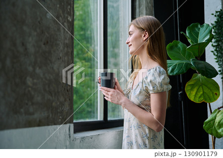 Young beautiful dreaming romantic girl looking out the window Young beautiful dreaming romantic girl looking out the window 130901179