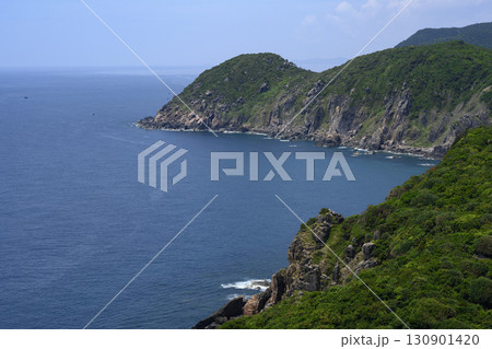 Steep mountain cliff and a national flag, and the South China Sea to the horizon in Vietnam Steep mountain cliff and a national flag, and the South China Sea to the horizon in Vietnam 130901420