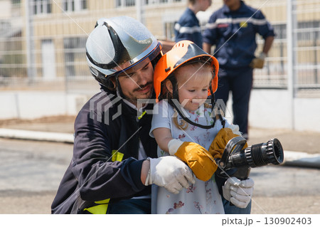 Father teaches his daughter Firefighter 130902403