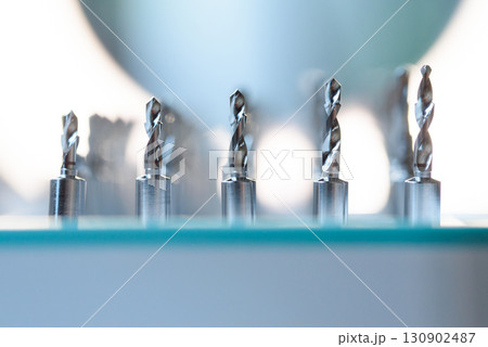 Full set of dental implant drill bits in surgical tray, close-up of professional dentistry equipment 130902487