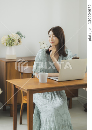 部屋でパソコンを見る女性 部屋でパソコンを見る女性 130904679