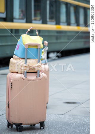 Colorful Luggage and Bags Stacked Near a Train Station Platform Colorful Luggage and Bags Stacked Near a Train Station Platform 130905384