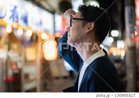 飲食店街を歩く男性 130905827