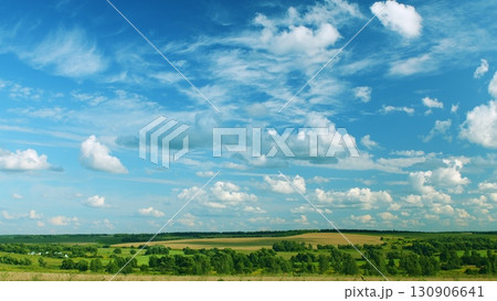 A Serene and Picturesque Landscape Featuring Fluffy Clouds and Lush Green Fields A Serene and Picturesque Landscape Featuring Fluffy Clouds and Lush Green Fields 130906641
