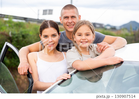 Happy family posing near new car Happy family posing near new car 130907514