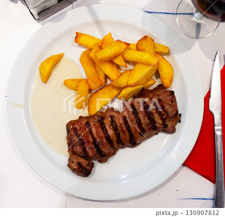 Tasty beef steak with baked potatoes and roquefort 130907812