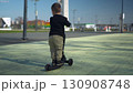 A Happy Child Riding a Bright Scooter in the Open Park, Enjoying an Adventurous Day 130908748