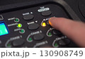 Man activates Blackout on lighting console - close-up of button press with blinking LED in 4K 130908749