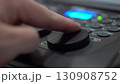 Close-up of finger adjusting Tilt shuttle on lighting console 130908752