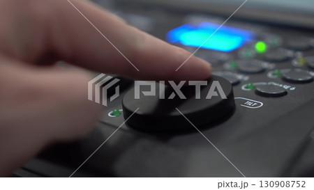 Close-up of finger adjusting Tilt shuttle on lighting console Close-up of finger adjusting Tilt shuttle on lighting console 130908752