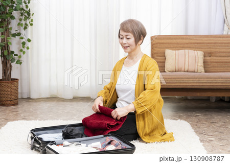 旅行の荷造りをするシニア女性 130908787
