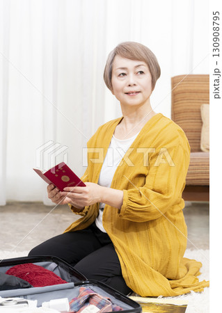 旅行の荷造りをするシニア女性 130908795