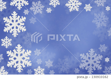 Christmas blue background of white snowflakes flying in the air. Holiday card for New Year and Christmas with space for greetings, labels and your design. 130910162